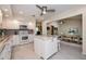 Open-concept kitchen with white cabinets, center island, and seamless flow to dining at 2256 Auburn Blvd, Port Charlotte, FL 33948