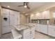 Beautiful kitchen with white cabinets, center island, and stainless steel refrigerator at 2256 Auburn Blvd, Port Charlotte, FL 33948