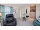 Cozy living room with plush armchairs, neutral carpet and sheer window curtains at 2256 Auburn Blvd, Port Charlotte, FL 33948