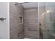 Shower with gray-tiled surround and safety grab bars at 2256 Auburn Blvd, Port Charlotte, FL 33948