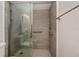 Well-lit bathroom featuring modern tile shower with glass door, bench, and grab bars at 2256 Auburn Blvd, Port Charlotte, FL 33948