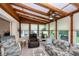 Bright sunroom boasts wood beams, a ceiling fan, and lots of natural light at 2256 Auburn Blvd, Port Charlotte, FL 33948