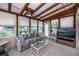 Cozy sunroom with wood beam ceiling offers serene views and relaxed seating at 2256 Auburn Blvd, Port Charlotte, FL 33948