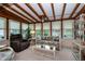 Inviting sunroom features a beamed ceiling, multiple windows, and comfortable seating at 2256 Auburn Blvd, Port Charlotte, FL 33948