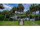 Scenic waterfront view with private boat dock, lush tropical landscaping, and direct water access at 2256 Auburn Blvd, Port Charlotte, FL 33948