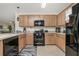 Well-equipped kitchen featuring black appliances at 7457 W Lenox Cir, Punta Gorda, FL 33950