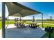 Picnic pavilion with tables, grills, and views of a pond at 7457 W Lenox Cir, Punta Gorda, FL 33950