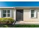 Front entrance of the home with landscaping and storm door at 7457 W Lenox Cir, Punta Gorda, FL 33950