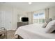 Comfortable main bedroom with a king-size bed and ensuite bathroom at 7457 W Lenox Cir, Punta Gorda, FL 33950