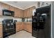 Modern kitchen with black appliances and wood cabinets at 7457 W Lenox Cir, Punta Gorda, FL 33950