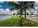 Beautiful community lake with lush landscaping and palm trees at 7457 W Lenox Cir, Punta Gorda, FL 33950