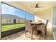 Relaxing screened porch with patio furniture and ceiling fan at 7457 W Lenox Cir, Punta Gorda, FL 33950