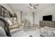 Bright living room featuring comfortable seating, a large TV, and sliding glass doors at 7457 W Lenox Cir, Punta Gorda, FL 33950