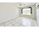 Bright bedroom with tile floors and a window with blinds at 2673 Greendale Rd, North Port, FL 34287