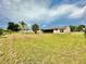 Large backyard with mature trees and landscaping at 2673 Greendale Rd, North Port, FL 34287