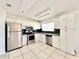 Modern kitchen with stainless steel appliances and white cabinets at 2673 Greendale Rd, North Port, FL 34287