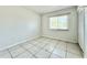 Simple bedroom with tile floors and a window with blinds at 2673 Greendale Rd, North Port, FL 34287