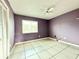 Simple bedroom with tile floors and a ceiling fan at 2673 Greendale Rd, North Port, FL 34287