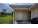 Well-maintained storage shed with a white door, located in the backyard at 2256 Auburn Blvd, Port Charlotte, FL 33948