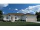One-story home with beige exterior, two-car garage, and landscaped lawn at 378 Lawler St, Port Charlotte, FL 33954