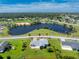 Aerial view of single-Gathering home with large backyard and lake nearby at 6420 Drucker Cir, Port Charlotte, FL 33981