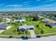 Aerial view of single-Gathering home with palm trees and large yard at 6420 Drucker Cir, Port Charlotte, FL 33981