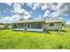 Large backyard with screened patio and grassy area at 20222 Banner Ave, Port Charlotte, FL 33952