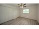 Bright bedroom featuring grey laminate flooring and double door closets at 20222 Banner Ave, Port Charlotte, FL 33952