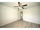 Spacious bedroom with grey laminate flooring and access to another room at 20222 Banner Ave, Port Charlotte, FL 33952