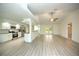 Open living room with kitchen, vaulted ceiling, and vinyl plank flooring at 20222 Banner Ave, Port Charlotte, FL 33952