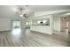 Open living room with kitchen, vaulted ceiling, and vinyl plank flooring at 20222 Banner Ave, Port Charlotte, FL 33952