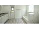 Modern bathroom with white tile and granite vanity at 20222 Banner Ave, Port Charlotte, FL 33952
