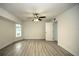 Bright bedroom features wood-look floors and a ceiling fan at 20222 Banner Ave, Port Charlotte, FL 33952