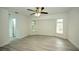Spacious bedroom with ceiling fan and wood-look flooring at 20222 Banner Ave, Port Charlotte, FL 33952
