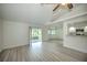 Bright living room with vaulted ceiling, vinyl plank flooring, and sliding glass doors at 20222 Banner Ave, Port Charlotte, FL 33952