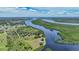 Aerial view of waterfront property with lush landscaping at 29165 Orva Dr, Punta Gorda, FL 33982