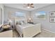 Guest bedroom with a queen bed, ceiling fan, and two windows at 108 Boundary Blvd # A&B, Rotonda West, FL 33947