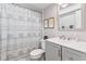 Clean bathroom with a shower/tub combo, vanity, and beach-themed decor at 108 Boundary Blvd # A&B, Rotonda West, FL 33947