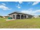 House exterior showcasing a large screened porch and backyard at 108 Boundary Blvd # A&B, Rotonda West, FL 33947