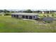 Gray duplex with screened porch and paved parking area at 108 Boundary Blvd # A&B, Rotonda West, FL 33947