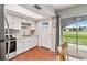 Bright kitchen features white cabinets, stainless steel appliances, and tile floors at 108 Boundary Blvd # A&B, Rotonda West, FL 33947