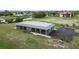 Gray duplex with screened porch and paved parking area at 108 Boundary Blvd # A&B, Rotonda West, FL 33947