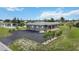 Single story home near water with bridge in distance at 108 Boundary Blvd # A&B, Rotonda West, FL 33947