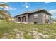 Gray duplex with a red door and spacious lawn at 108 Boundary Blvd # A&B, Rotonda West, FL 33947