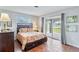 Bedroom with a queen-size bed and sliding door access to patio at 108 Boundary Blvd # A&B, Rotonda West, FL 33947