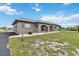 Single story home with a gray exterior and a manicured lawn at 108 Boundary Blvd # A&B, Rotonda West, FL 33947
