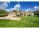 Single-story home with two-car garage and lush lawn at 5551 Reisterstown Rd, North Port, FL 34291