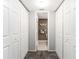 Hallway with built-in closets leading to the bathroom at 1400 Mineo Dr # 12-A, Punta Gorda, FL 33950