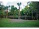 Backyard with lush landscaping and canal view at 1565 Dorchester St, Port Charlotte, FL 33952
