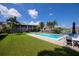 Community pool with lounge chairs and patio furniture at 3251 White Ibis Ct # C4, Punta Gorda, FL 33950